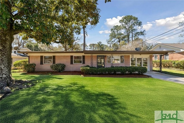 ranch-style house with a carport, concrete driveway, and a front lawn