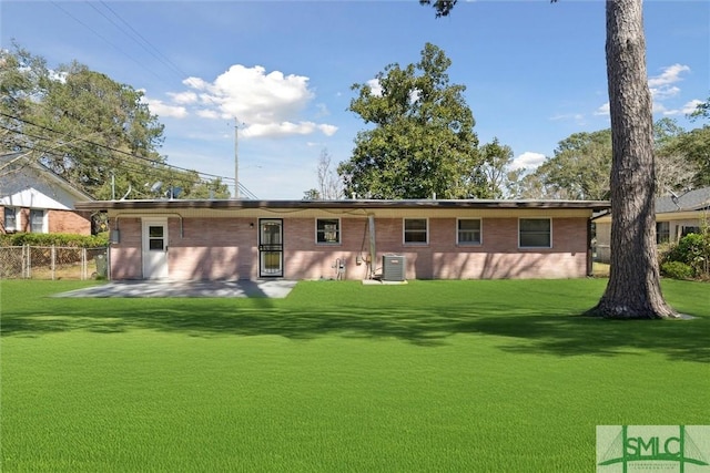 back of property with central AC, a yard, a patio, and fence