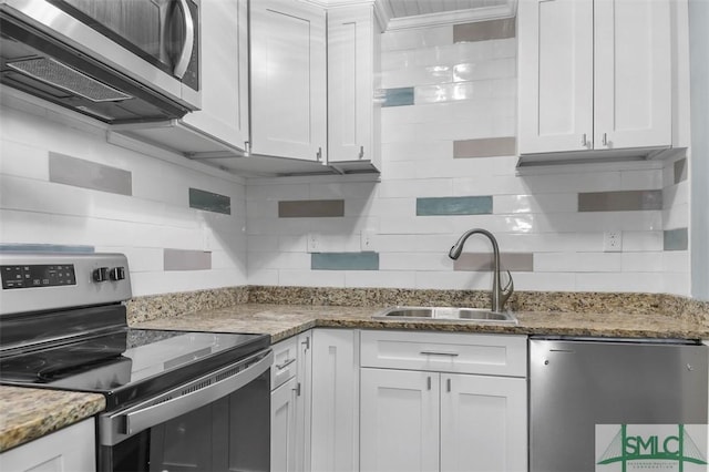 kitchen with white cabinetry, appliances with stainless steel finishes, decorative backsplash, and a sink