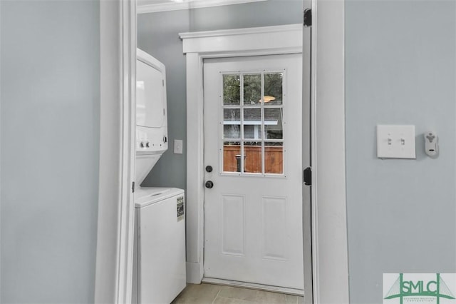 laundry room featuring laundry area and stacked washer / drying machine