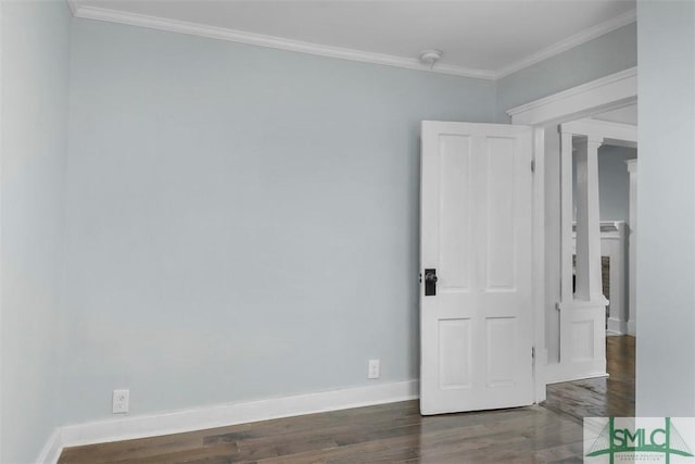 empty room featuring ornate columns, baseboards, ornamental molding, and wood finished floors