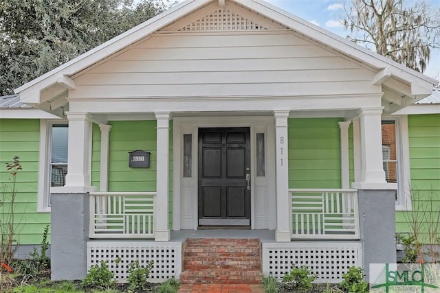 entrance to property featuring covered porch