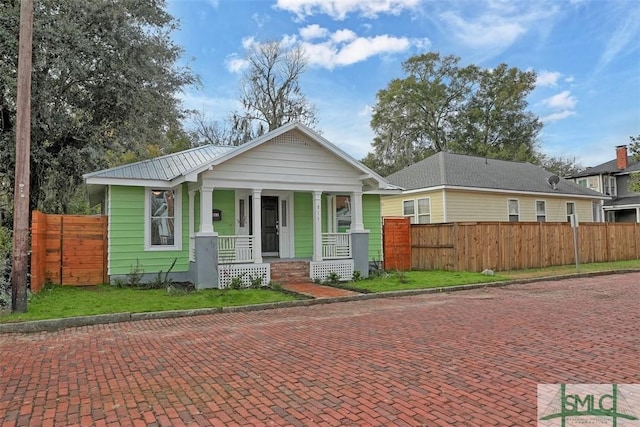 bungalow with covered porch and fence