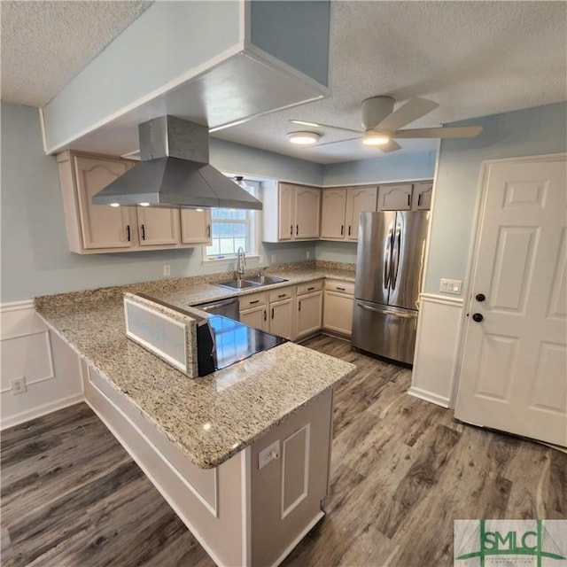 kitchen with a peninsula, island exhaust hood, dark wood-style flooring, a sink, and appliances with stainless steel finishes