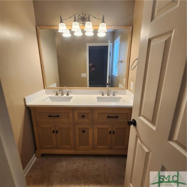 full bath featuring double vanity, baseboards, tile patterned floors, and a sink