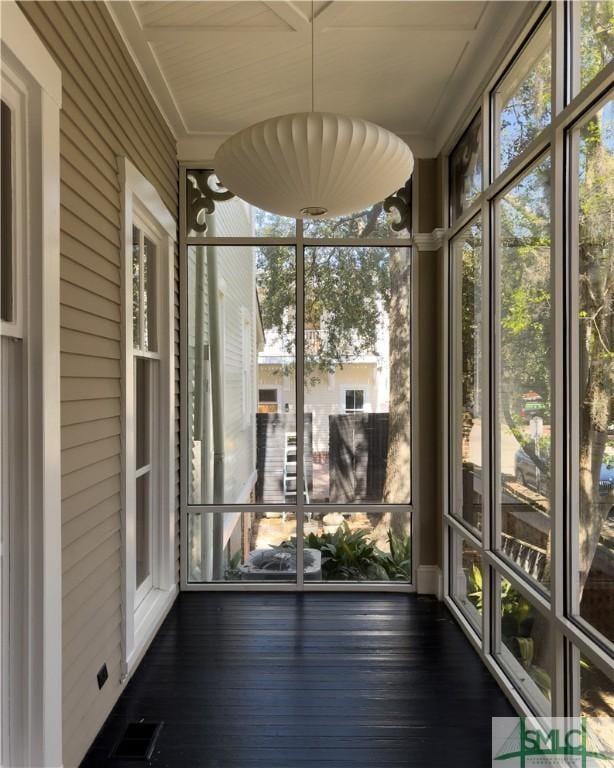 unfurnished sunroom featuring visible vents