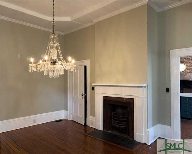 unfurnished living room featuring hardwood / wood-style floors, visible vents, baseboards, a fireplace, and ornamental molding