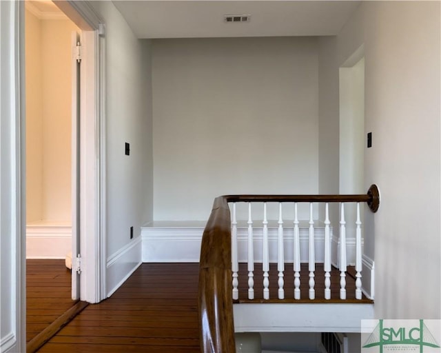 interior space featuring visible vents, baseboards, and hardwood / wood-style flooring