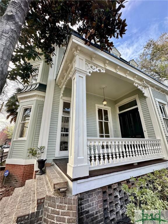 view of side of home with a porch