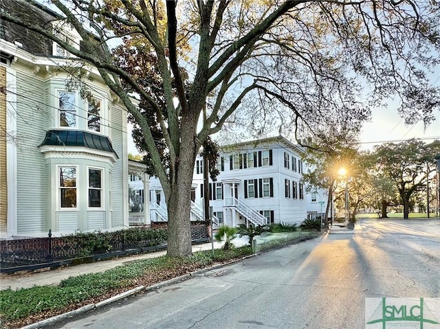 view of front of house with curbs