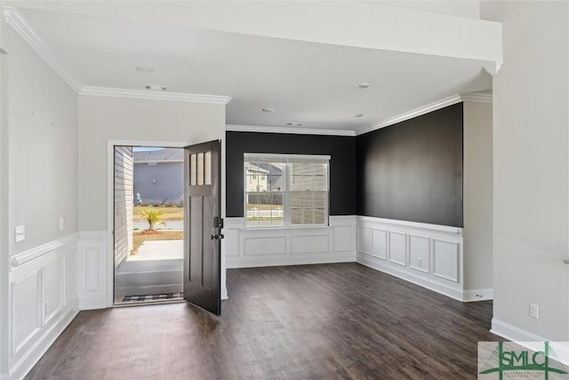 foyer featuring a wainscoted wall, visible vents, crown molding, and wood finished floors