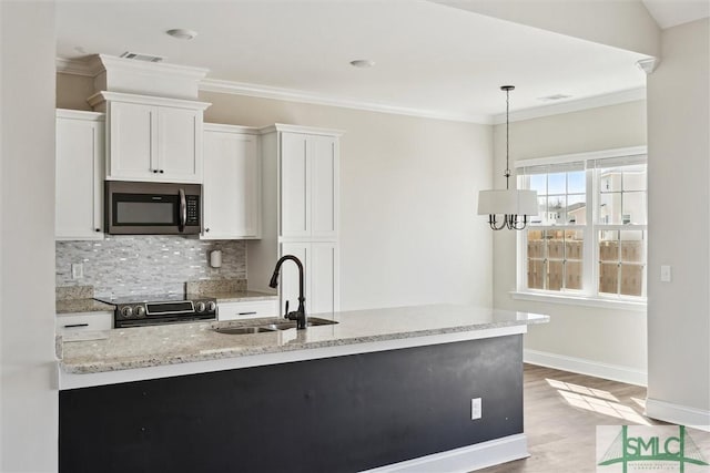 kitchen with crown molding, tasteful backsplash, visible vents, appliances with stainless steel finishes, and a sink