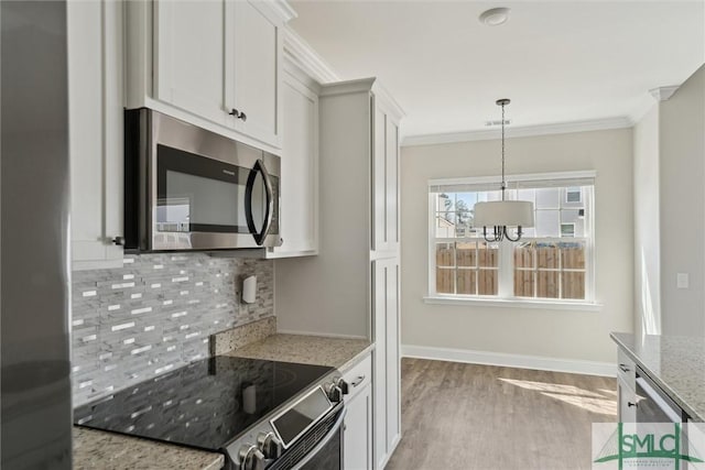 kitchen featuring stainless steel microwave, crown molding, electric range, and decorative backsplash