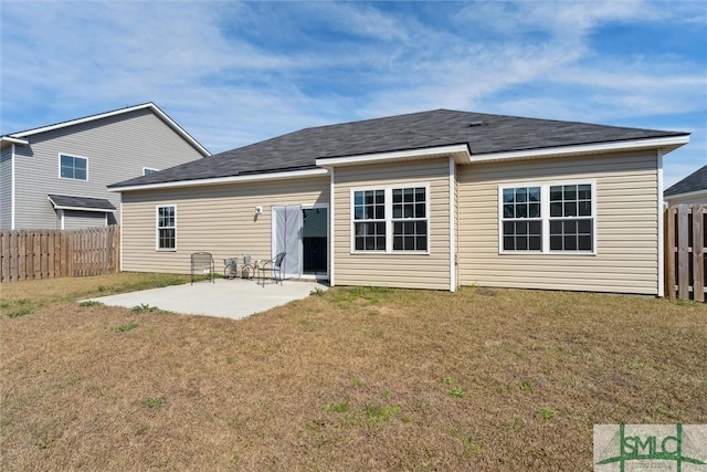 rear view of property with a patio area, fence, and a lawn