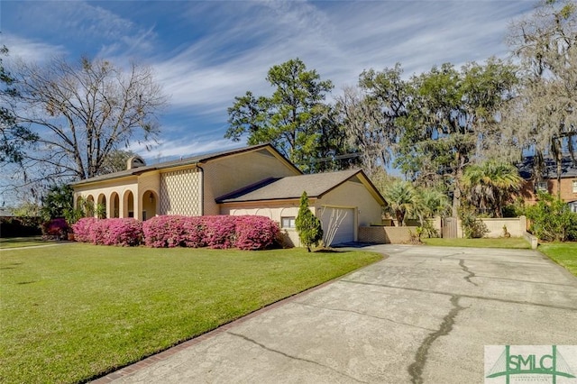 view of front of house featuring an attached garage, fence, driveway, a chimney, and a front yard