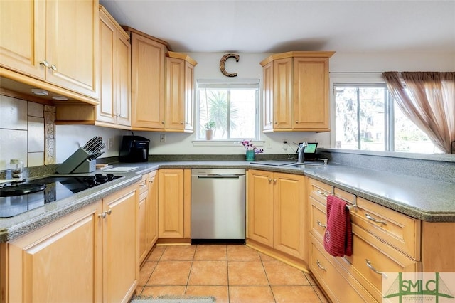 kitchen featuring a peninsula, black electric cooktop, light brown cabinetry, stainless steel dishwasher, and light tile patterned flooring