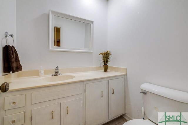 bathroom featuring toilet and vanity