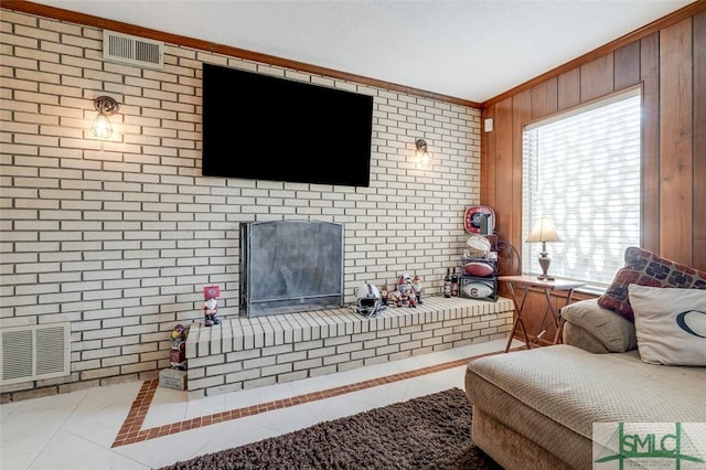 tiled living area with a wealth of natural light, visible vents, and crown molding