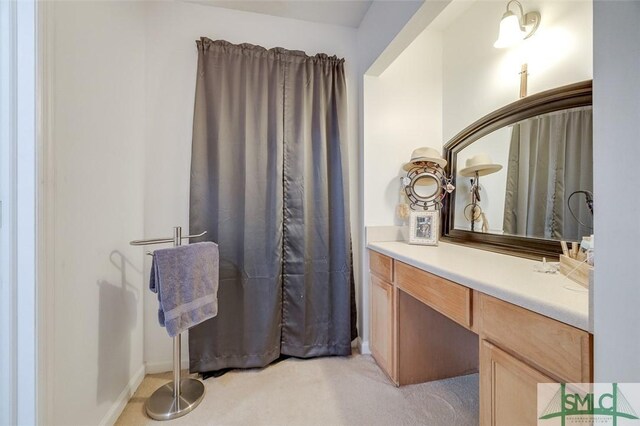 bathroom featuring baseboards and vanity