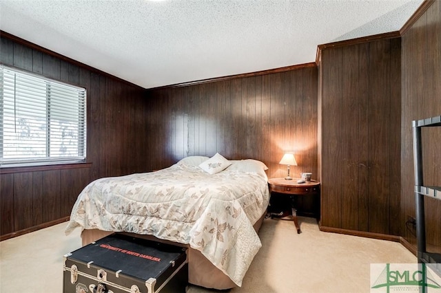 bedroom with carpet floors, wooden walls, and a textured ceiling