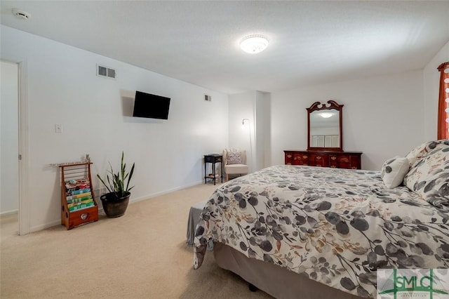 carpeted bedroom featuring visible vents and baseboards