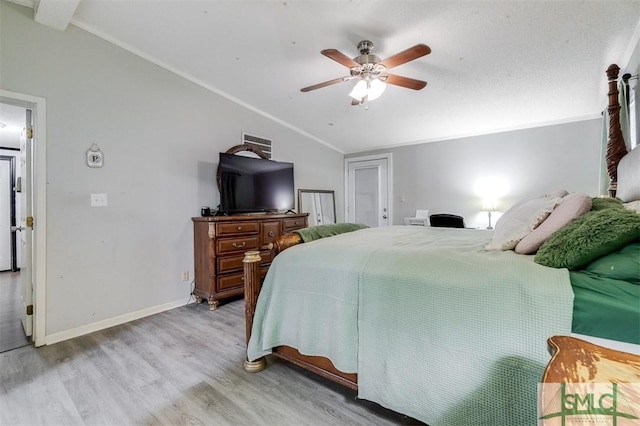 bedroom with baseboards, a ceiling fan, lofted ceiling, light wood-style flooring, and ornamental molding