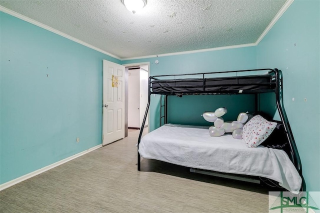 unfurnished bedroom featuring baseboards, a textured ceiling, and crown molding