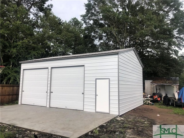 view of outdoor structure with an outbuilding and fence