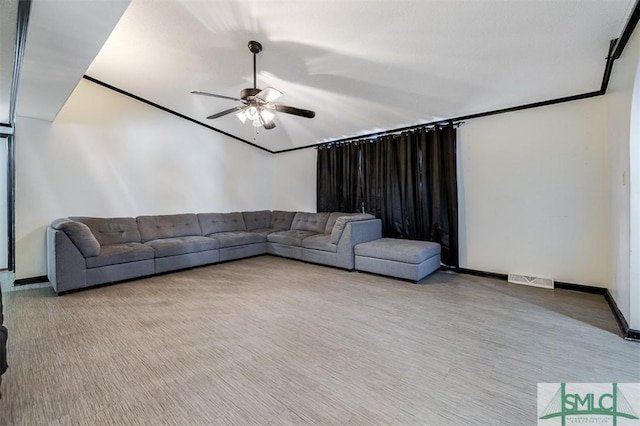 unfurnished living room featuring ceiling fan, visible vents, and baseboards