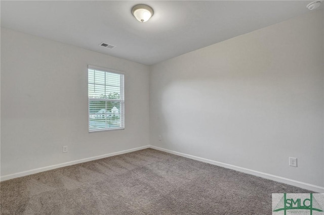 unfurnished room featuring visible vents, baseboards, and carpet flooring