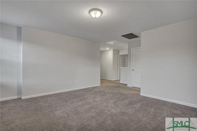 carpeted spare room with visible vents and baseboards