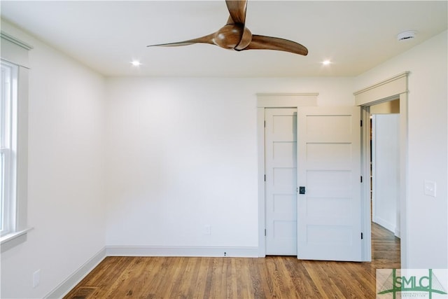 unfurnished bedroom with a ceiling fan, baseboards, wood finished floors, and recessed lighting