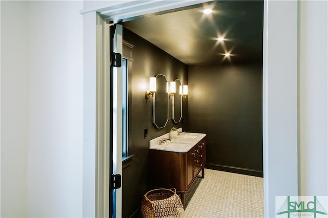 bathroom featuring baseboards and vanity