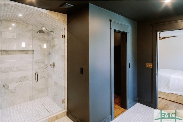 full bath with a shower stall and wood finished floors