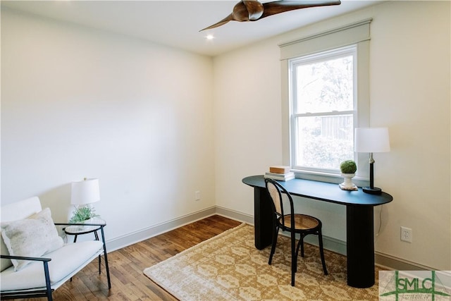 office with wood finished floors, a ceiling fan, and baseboards