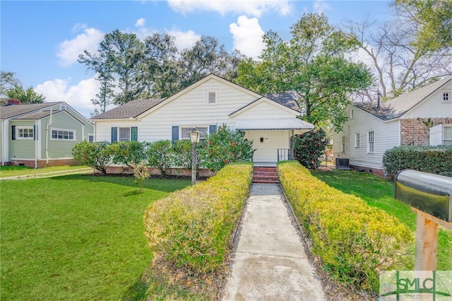 ranch-style home featuring central AC unit and a front yard