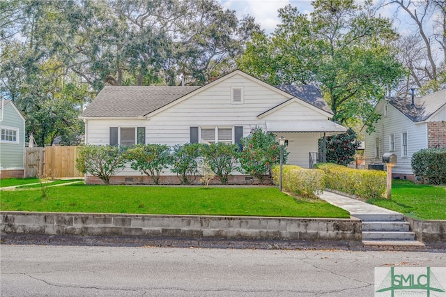 single story home featuring a shingled roof, a front yard, crawl space, and fence