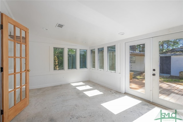 unfurnished sunroom with a healthy amount of sunlight, lofted ceiling, visible vents, and french doors