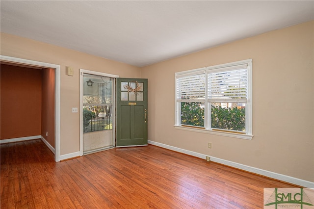 entryway featuring baseboards and wood finished floors