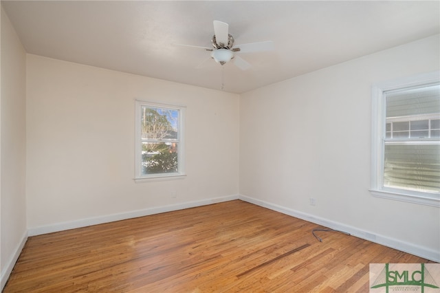 empty room featuring light wood-style floors, ceiling fan, and baseboards