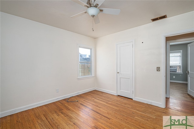 unfurnished bedroom with ceiling fan, light wood-style flooring, visible vents, and baseboards