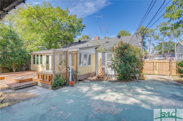 back of property featuring fence and a wooden deck