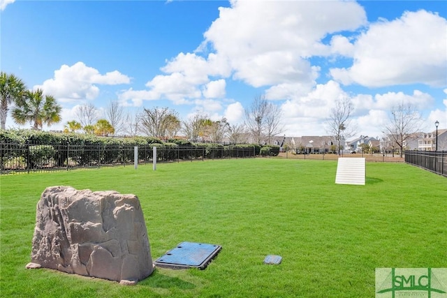 exterior space featuring a lawn and fence