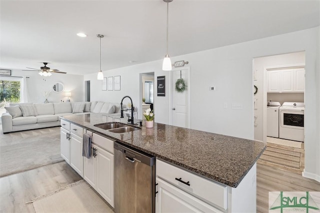 kitchen with open floor plan, dishwasher, a sink, and separate washer and dryer