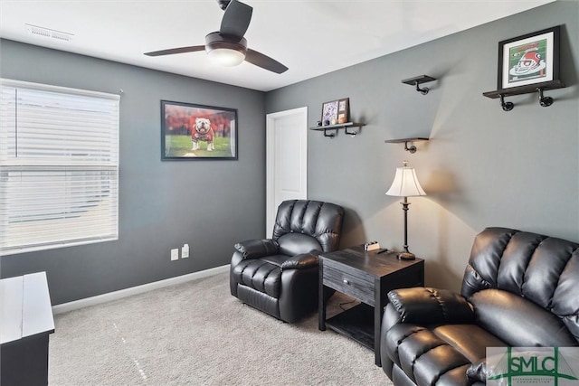 sitting room with a ceiling fan, carpet, visible vents, and baseboards