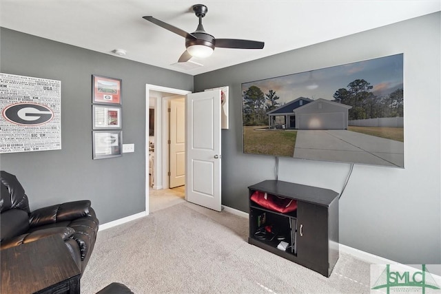 sitting room featuring ceiling fan, baseboards, and carpet flooring