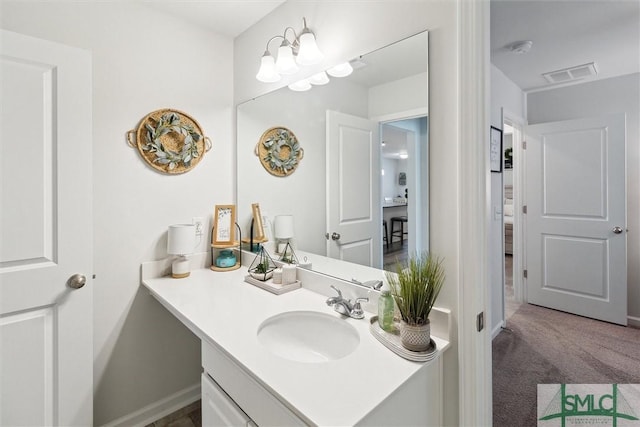 bathroom featuring baseboards, visible vents, and vanity