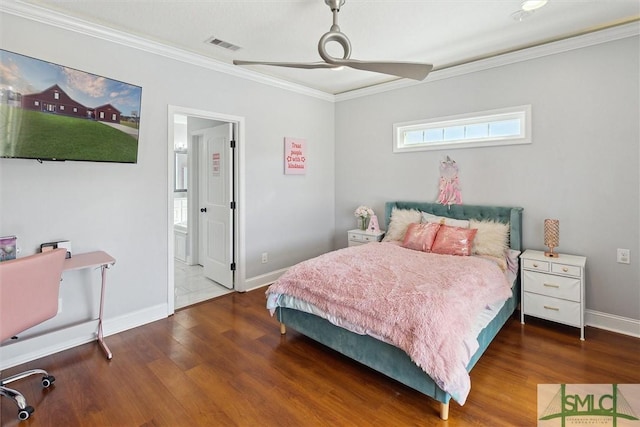 bedroom featuring baseboards, wood finished floors, visible vents, and crown molding