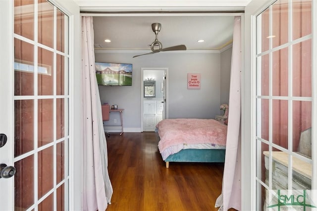 bedroom with baseboards, dark wood finished floors, crown molding, and recessed lighting