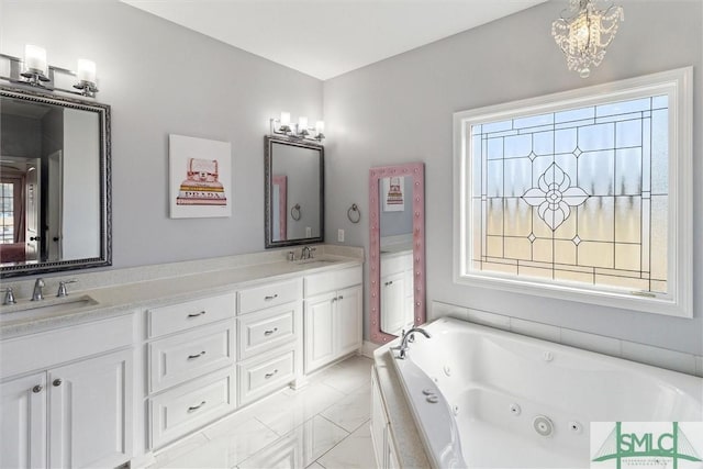 bathroom featuring a jetted tub, double vanity, and a sink